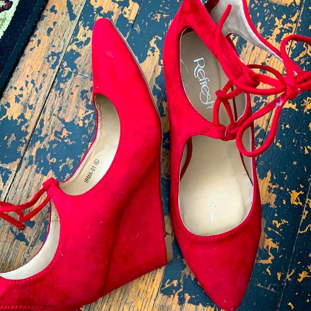 Pointed toe red heels, with a fun tie on the top and slight wedge.